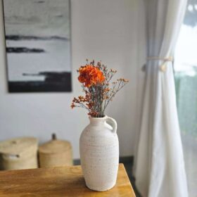 Artisan-crafted decorative accessory designed for functional and aesthetic appeal One-handled-vintage-vase Dried-orange-flowers-